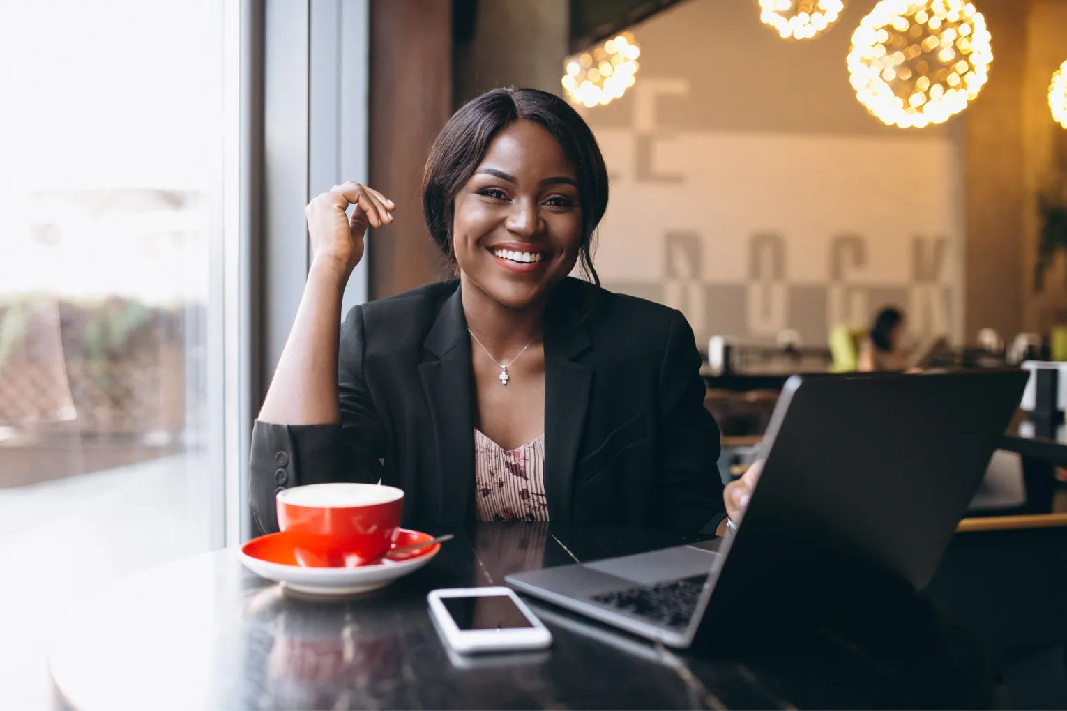 A young female professional working in a cafe